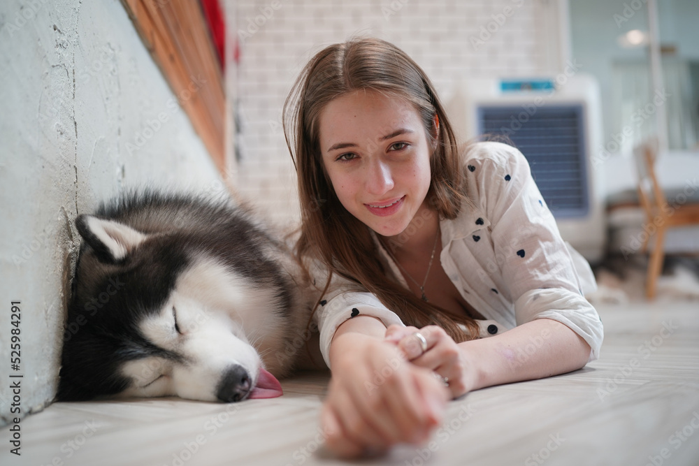 Young woman with her dog at modern house on nature light.