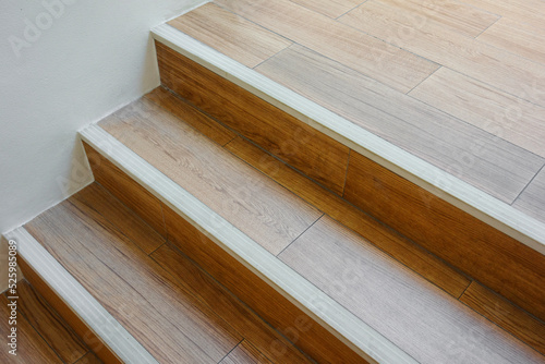 Modern wooden staircase with stair nosing strip.