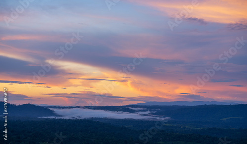 beautiful sunset landscape from the forest in the national park on top mountain. sunset twilight on the top mountain with sea of fog.