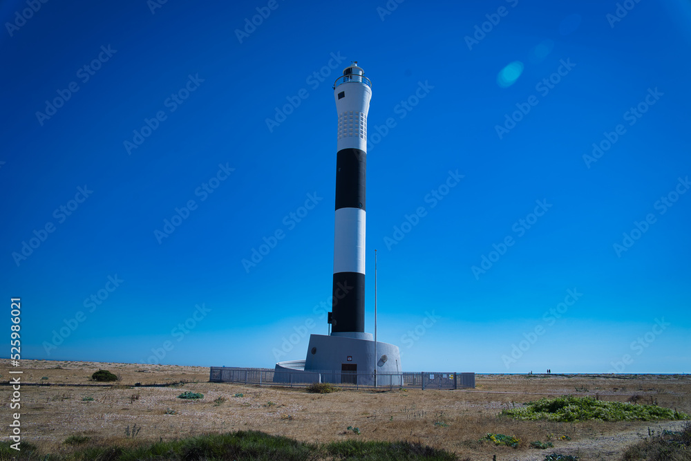 lighthouse in summer with blue sky