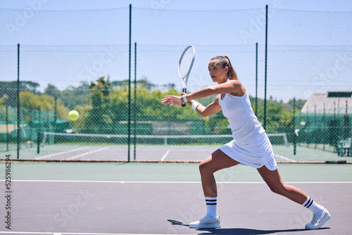 Fitness, exercise and sport with training tennis player playing competitive match at a tennis court. Woman athlete practicing cardio in a game. Young, strong player enjoying action and competition