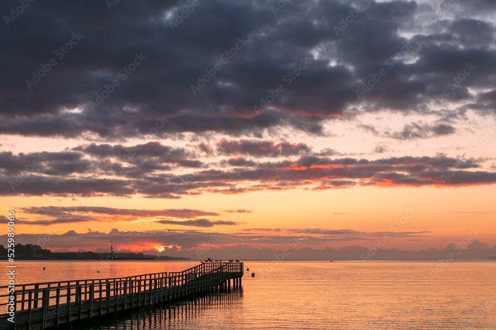 Silhouette of a pier at dawn.