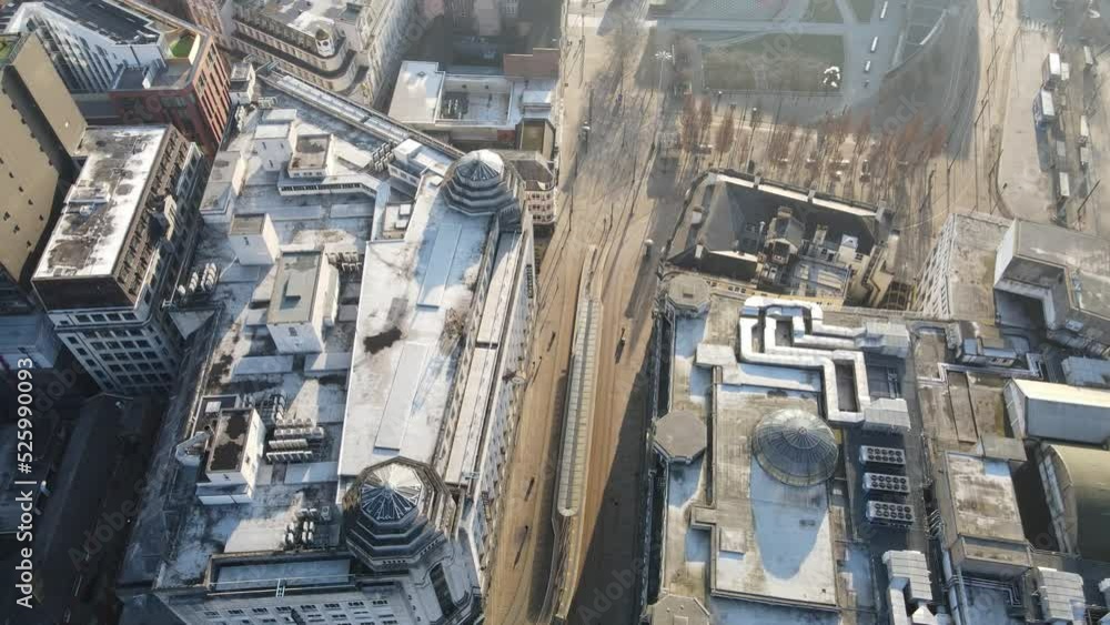 Aerial drone flight on a hazy sunny morning over Piccadilly Gardens in Manchester City Centre giving a birdseye view of the rootops and empty streets below Aerial drone flight on a hazy sunny morning over Piccadilly Gardens in Manchester City Centre giving a birdseye view of the rootops and empty streets below