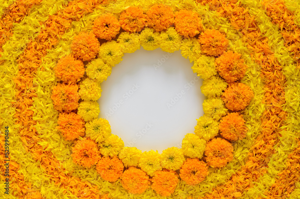 Decorative yellow and orange color marigold flowers and petals rangoli