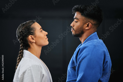 Foto Mma, martial arts and self defense training or practice with a man and woman having a face off in studio against a black background