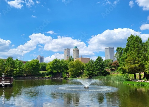 park with fountain and skyscrapers in background with trees