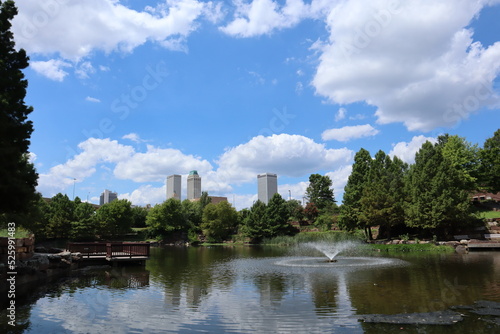 fountain in the park with city buildings