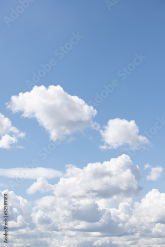 White large cumulus clouds in the blue sky.