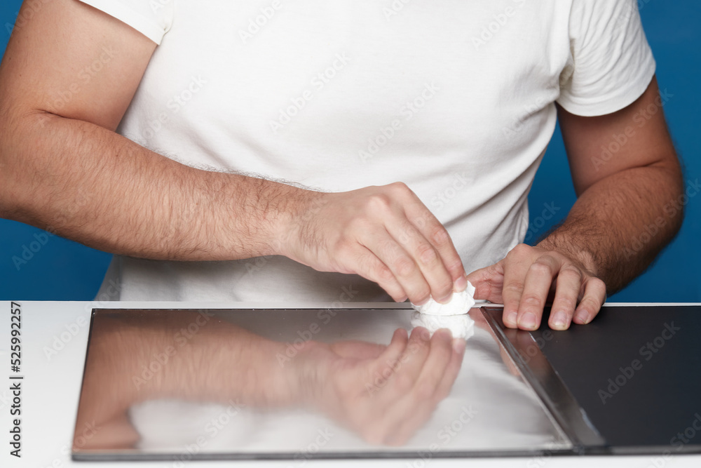 Person attaching a reflective cardboard to a black one Person attaching a reflective cardboard to a black one