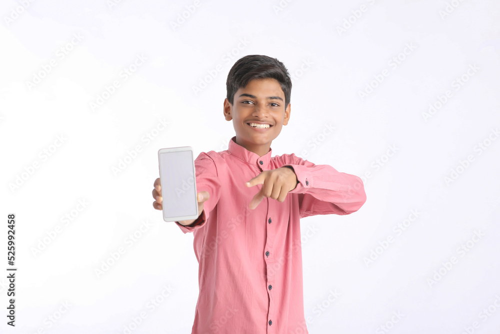 Indian college boy showing smartphone on white background.