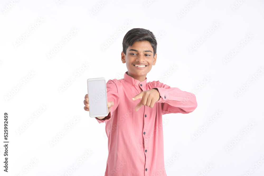 Indian college boy showing smartphone on white background. Indian college boy showing smartphone on white background.