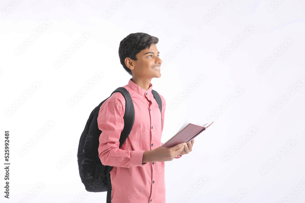 Indian college student holding diary in hand on white background. Indian college student holding diary in hand on white background.