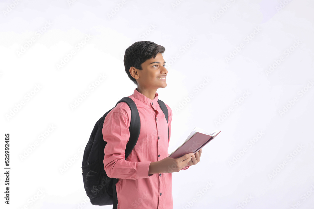 Indian college student holding diary in hand on white background. Indian college student holding diary in hand on white background.