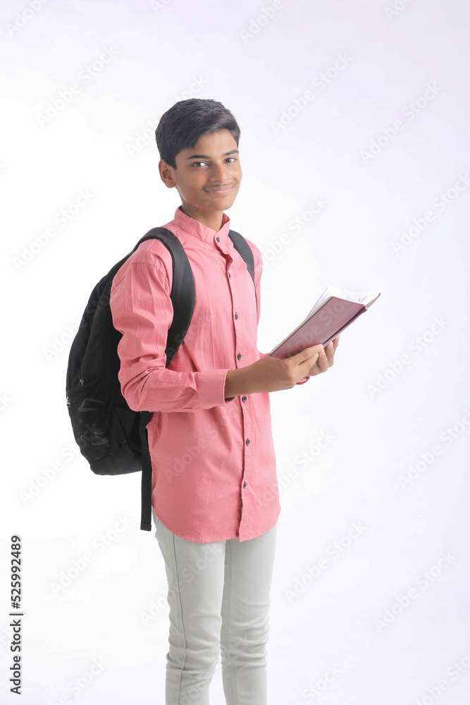 Indian college student holding diary in hand on white background. Indian college student holding diary in hand on white background.