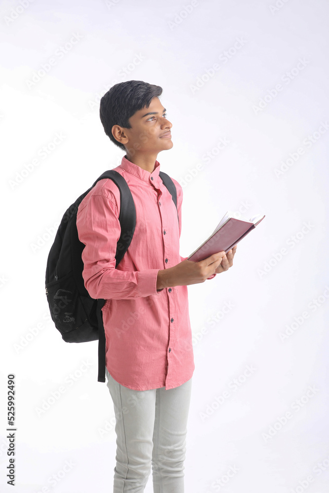 Indian college student holding diary in hand on white background. Indian college student holding diary in hand on white background.