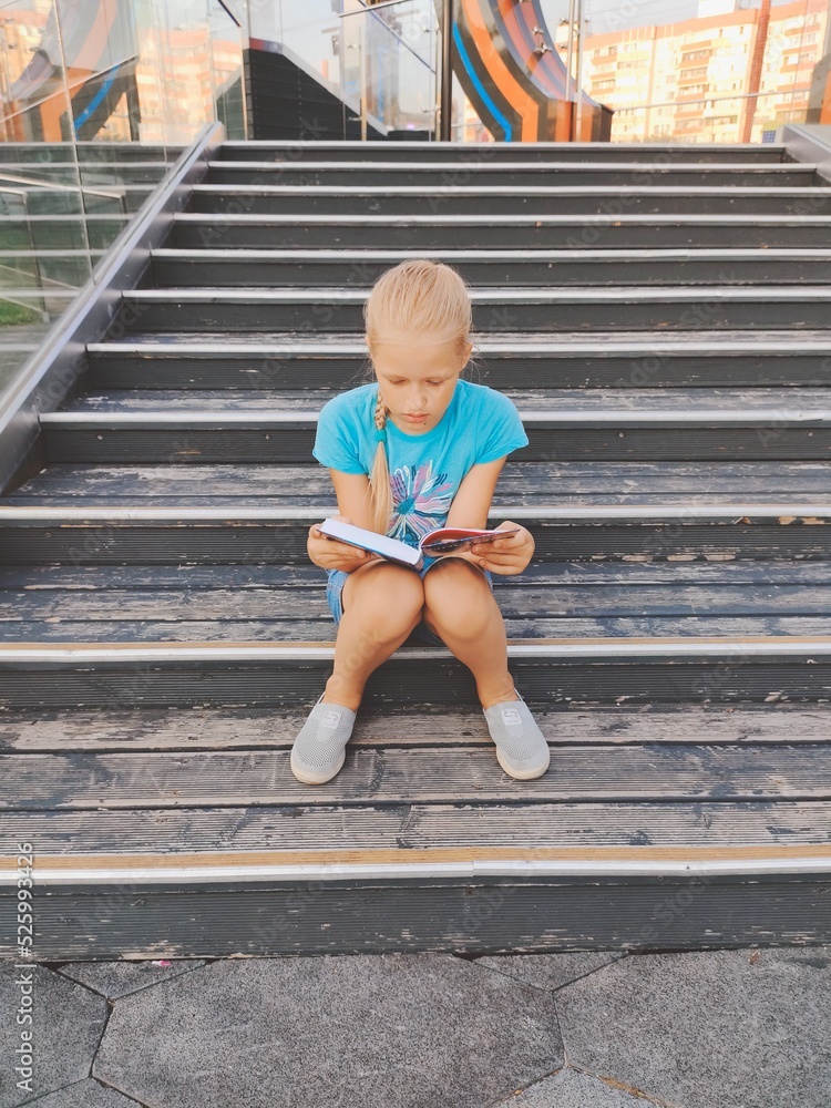 Girl reading a book outdoors Girl reading a book outdoors