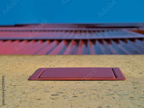 Red tin facade with maintenance hatch