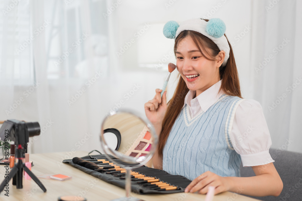 Beauty blogger concept, Young Asian woman use brush to review cosmetics in live streaming Beauty blogger concept, Young Asian woman use brush to review cosmetics in live streaming
