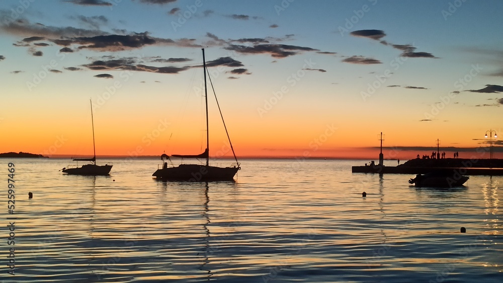 sun set on the sea boats