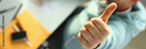 Fotografie Young designer holding thumb up gesture closeup