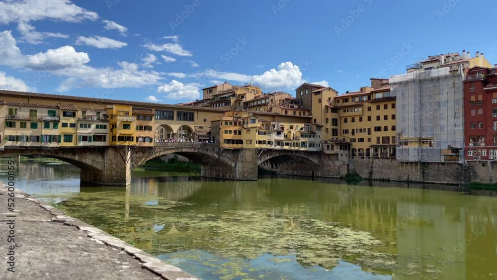 Side View of Medieval Ponte Vecchio Bridge in Florence Italy with Blue Skies Side View of Medieval Ponte Vecchio Bridge in Florence Italy with Blue Skies