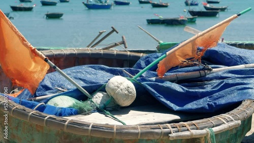 Close up shot of Traditional Vietnamese round coracle boat on island beach shore on a hot summer day. photo