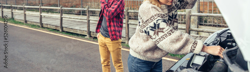 Photos Woman repairing broken down campervan while her husband calls on the phone