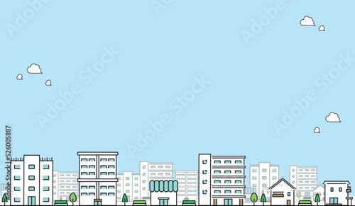 コピースペースがある青空と家・マンション・お店・ビルが連なる街並みの背景　Blue sky with copy space and a cityscape background with a series of houses, apartments, stores, and buildings