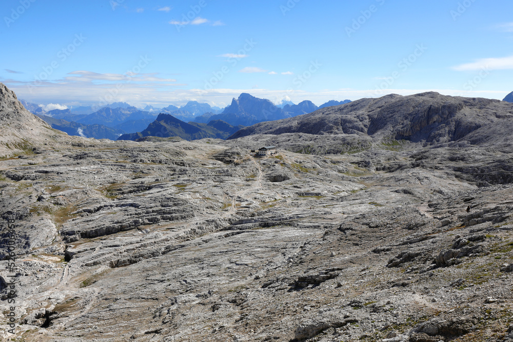 incredible mountain landscape in the Dolomites that looks like the lunar surface and an alpine refuge called Rifugio Rosetta incredible mountain landscape in the Dolomites that looks like the lunar surface and an alpine refuge called Rifugio Rosetta