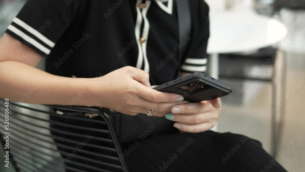 Hands of the woman using mobile phone sitting at a cafe - no face, slow motion Hands of the woman using mobile phone sitting at a cafe - no face, slow motion
