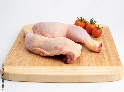 Raw chicken legs on a cutting board. Chicken legs on a white background.