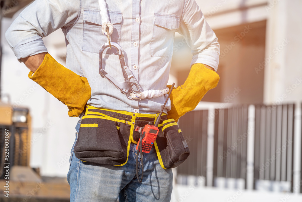 Technician wearing safety helmet standing at a construction site,Concept of architect profession and house building. Technician wearing safety helmet standing at a construction site,Concept of architect profession and house building.