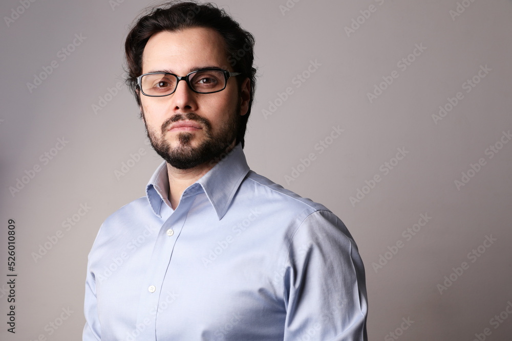 Young business man standing in corporate portrait isolated on white background Young business man standing in corporate portrait isolated on white background