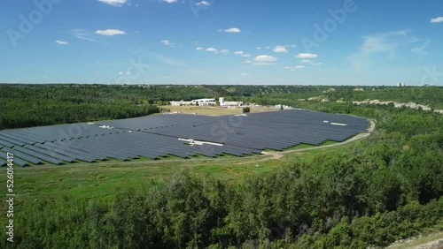 Green energy being produced by solar panels in humongous solar field in North American wilderness photo