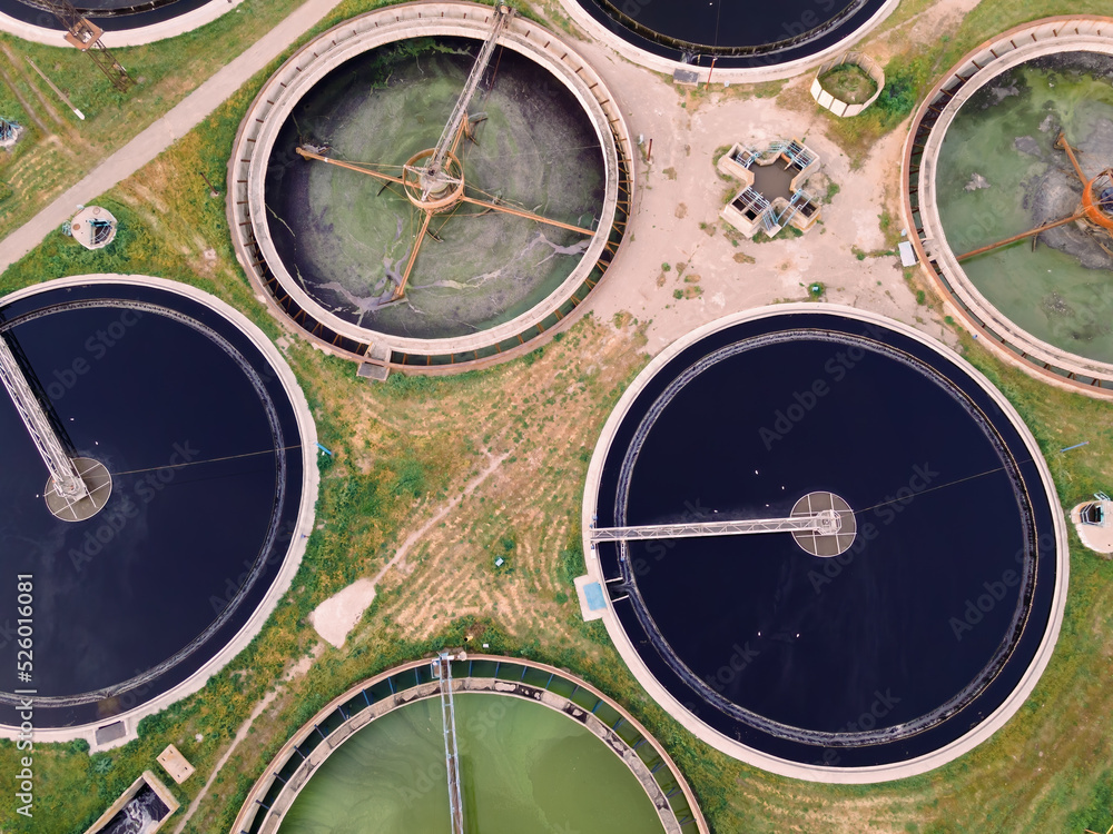 Wastewater treatment plant with round ponds for recycle dirty sewage water, aerial view Wastewater treatment plant with round ponds for recycle dirty sewage water, aerial view