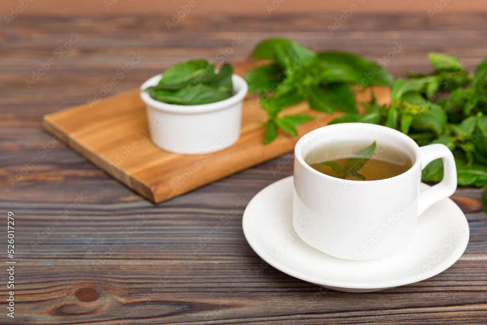 Cup of mint tea on table background. Green tea with fresh mint top view with copy space Cup of mint tea on table background. Green tea with fresh mint top view with copy space