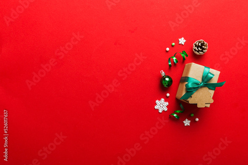 Top view Flat lay Christmas decorations and gift box on colored background with copy space. Christmas or Happy New Year composition