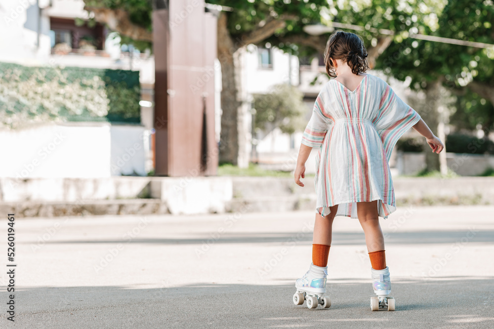 Anonymous girl riding roller skates on street Anonymous girl riding roller skates on street