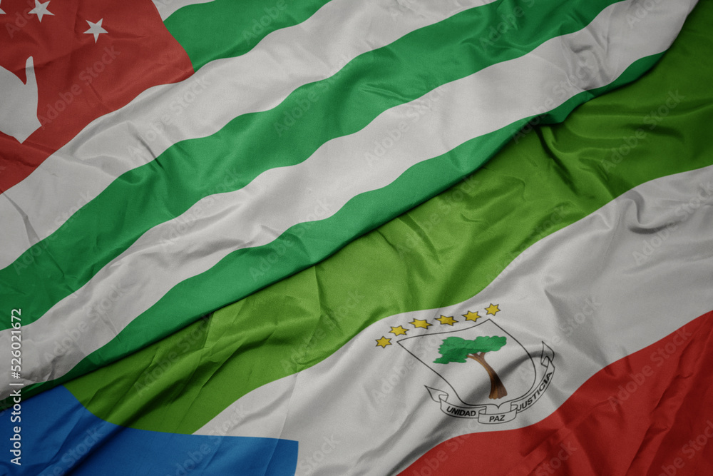 waving colorful flag of equatorial guinea and national flag of abkhazia.