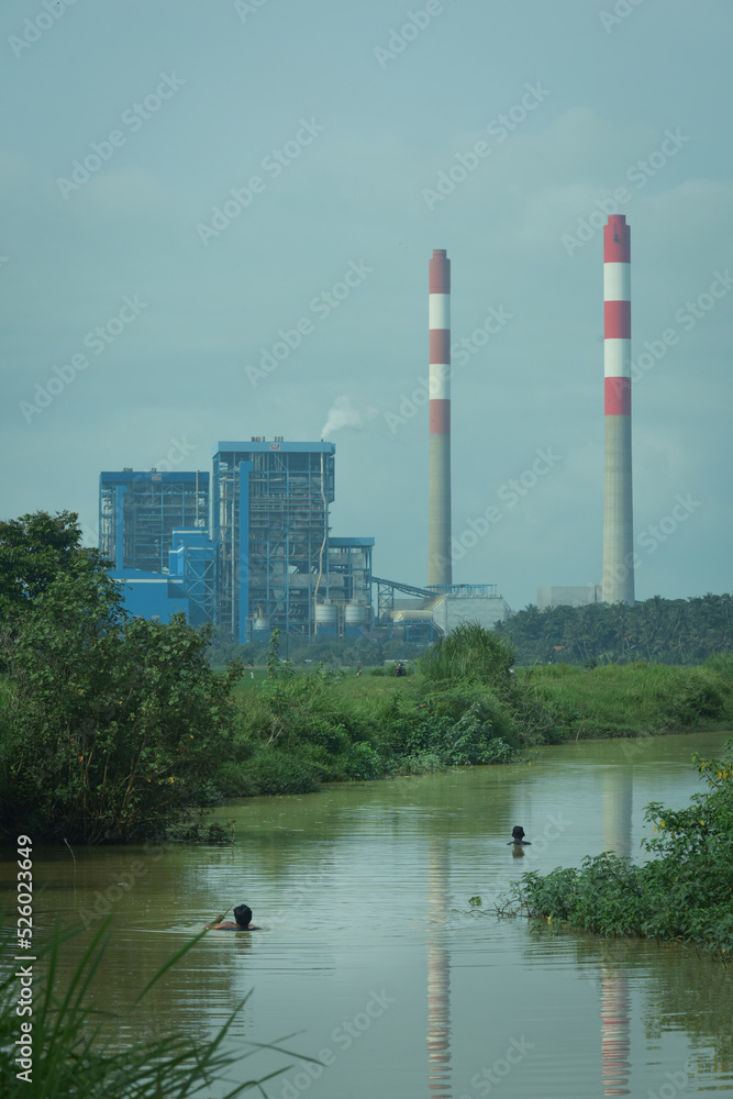 Obraz premium steam power plant in the middle of green environment.
