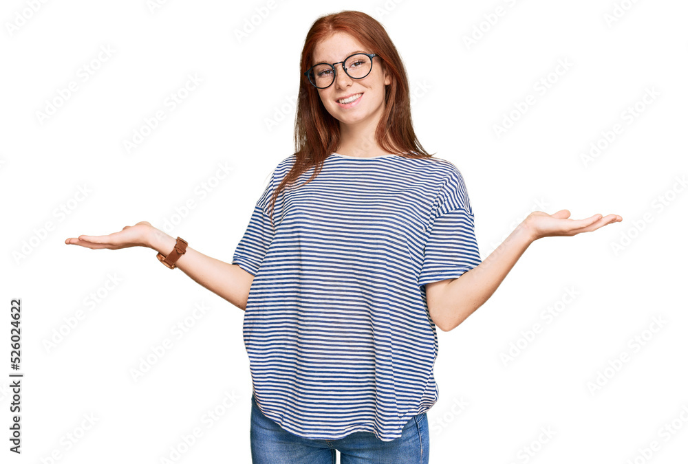 Young read head woman wearing casual clothes and glasses smiling showing both hands open palms, presenting and advertising comparison and balance Young read head woman wearing casual clothes and glasses smiling showing both hands open palms, presenting and advertising comparison and balance