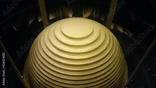 Closeup of a tuned mass damper with dark background