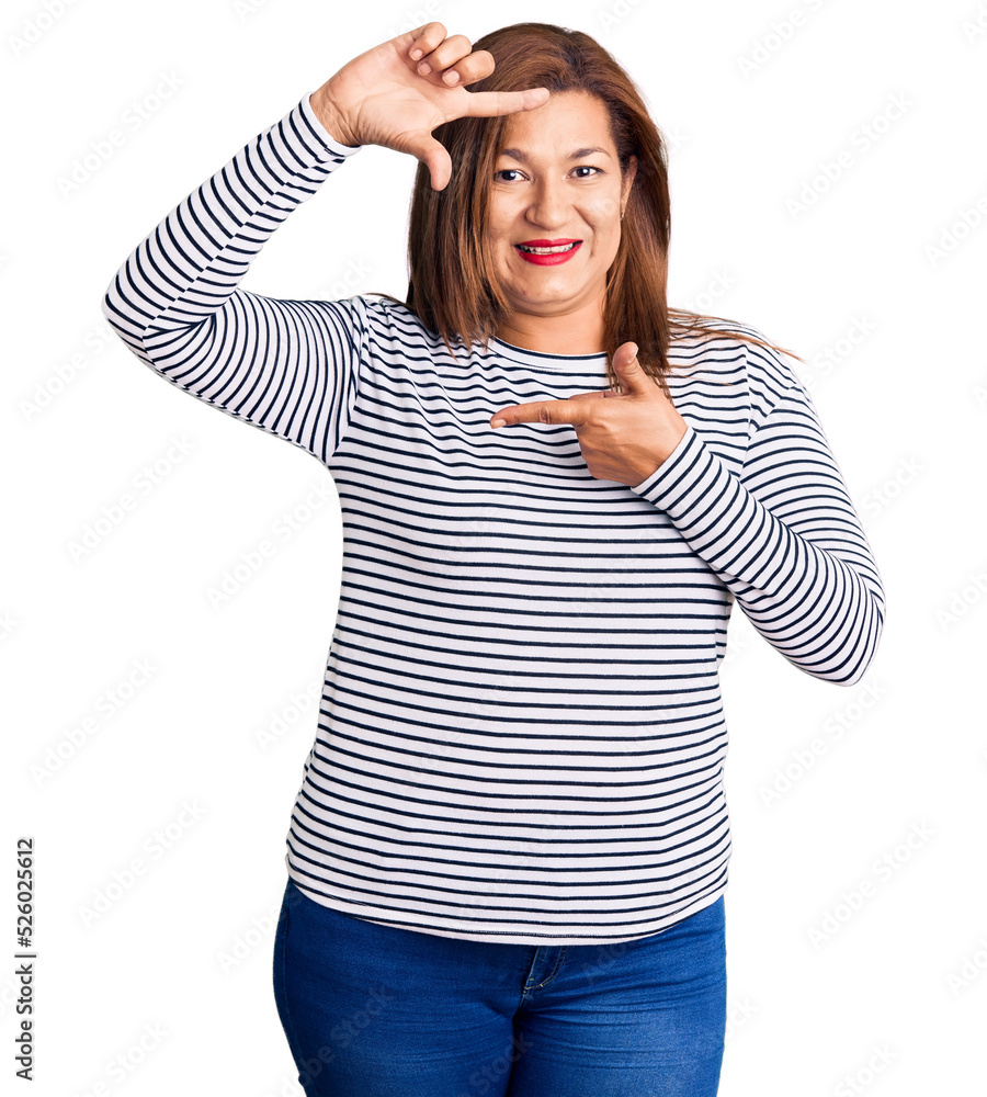 Middle age latin woman wearing casual clothes smiling making frame with hands and fingers with happy face. creativity and photography concept. Middle age latin woman wearing casual clothes smiling making frame with hands and fingers with happy face. creativity and photography concept.