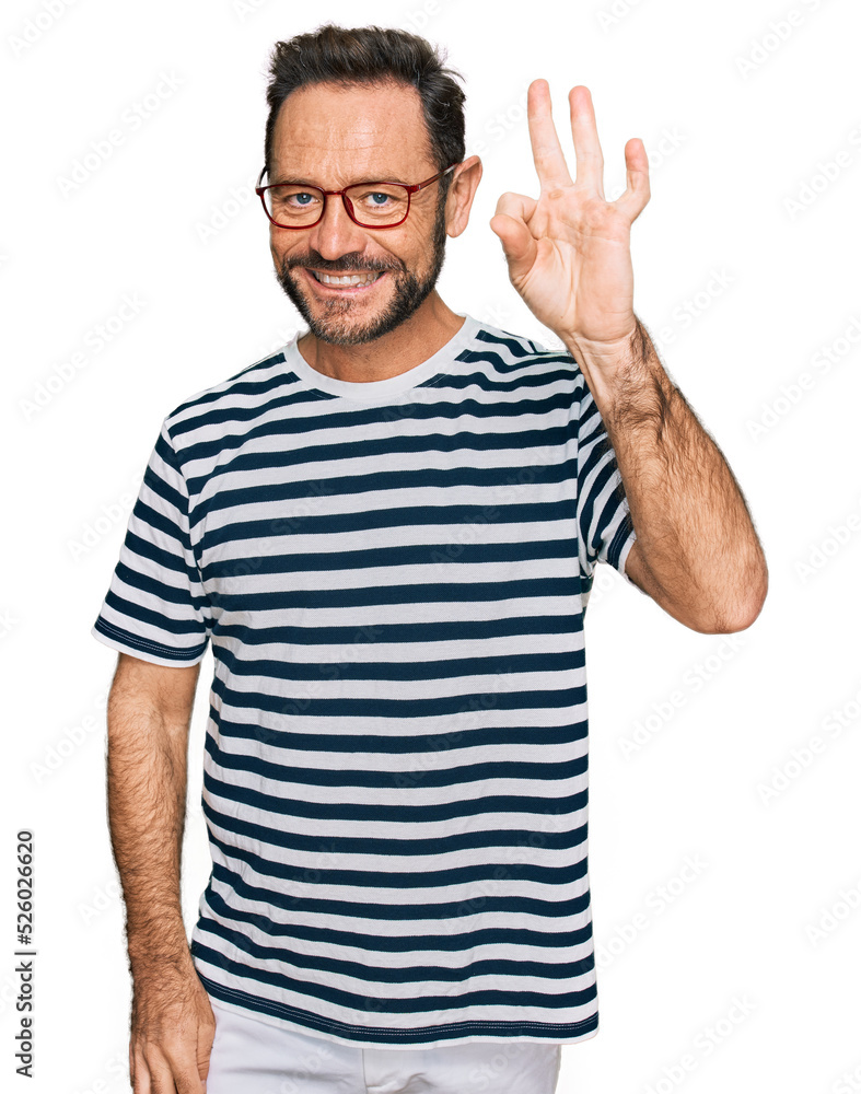 Middle age man wearing casual clothes and glasses smiling positive doing ok sign with hand and fingers. successful expression. Middle age man wearing casual clothes and glasses smiling positive doing ok sign with hand and fingers. successful expression.