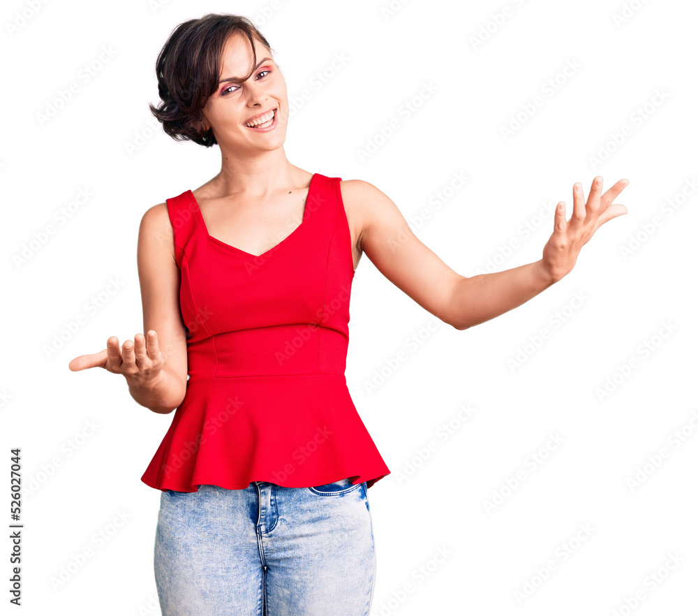 Beautiful young woman with short hair wearing casual style with sleeveless shirt smiling cheerful offering hands giving assistance and acceptance. Beautiful young woman with short hair wearing casual style with sleeveless shirt smiling cheerful offering hands giving assistance and acceptance.