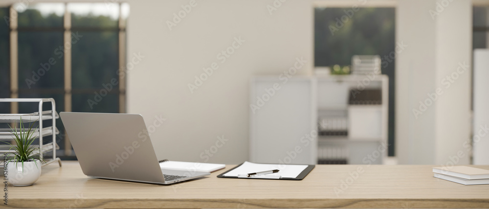 Modern office desk workspace with laptop, office accessories and space on wooden tabletop