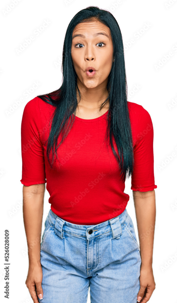 Fototapeta premium Beautiful hispanic woman wearing casual clothes afraid and shocked with surprise expression, fear and excited face.