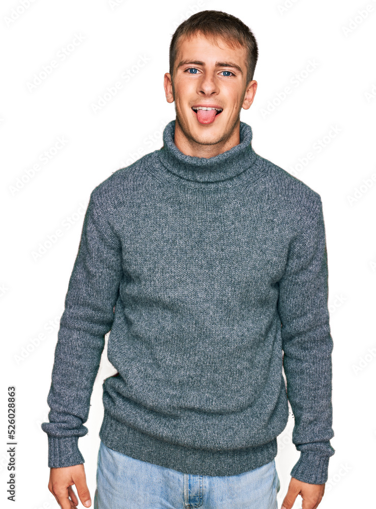 Young blond man wearing casual clothes sticking tongue out happy with funny expression. emotion concept. Young blond man wearing casual clothes sticking tongue out happy with funny expression. emotion concept.