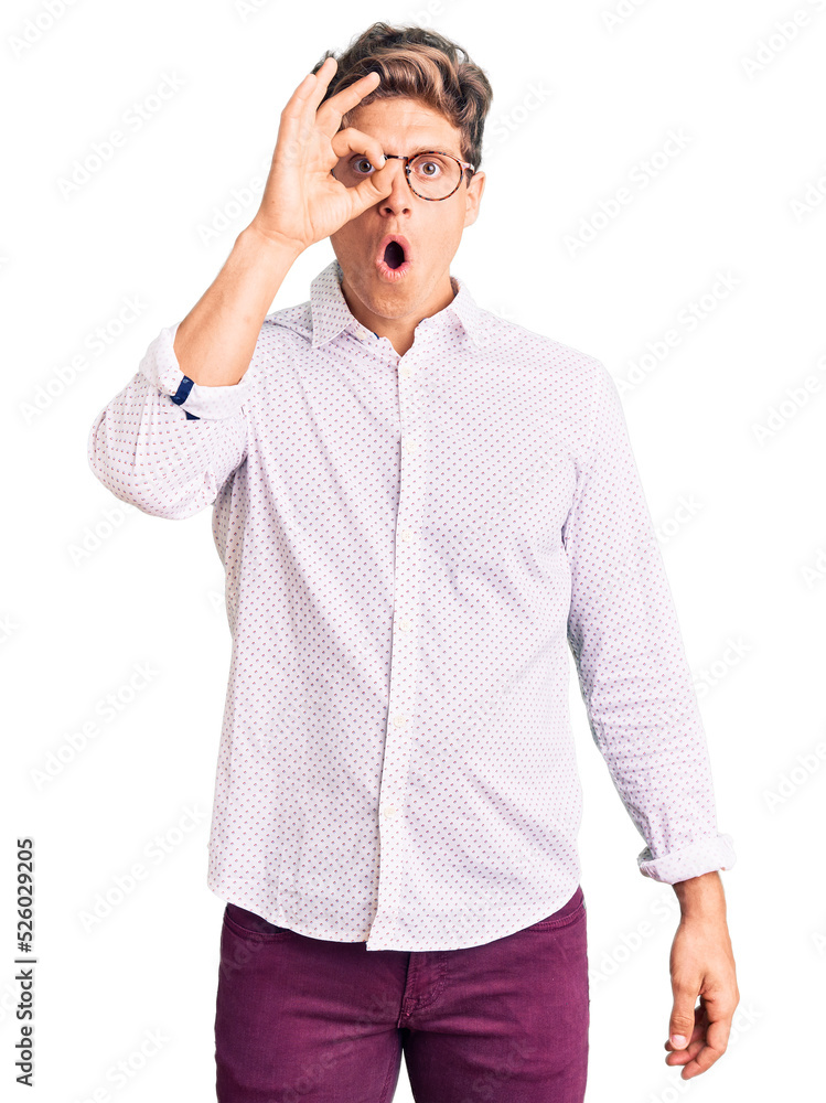 Young handsome man wearing business clothes and glasses doing ok gesture shocked with surprised face, eye looking through fingers. unbelieving expression. Young handsome man wearing business clothes and glasses doing ok gesture shocked with surprised face, eye looking through fingers. unbelieving expression.