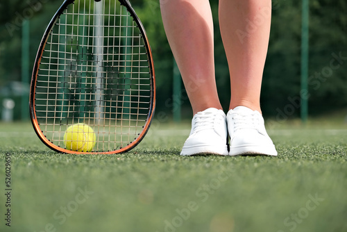 legs and tennis racket close-up. ball and racket on the tennis court.